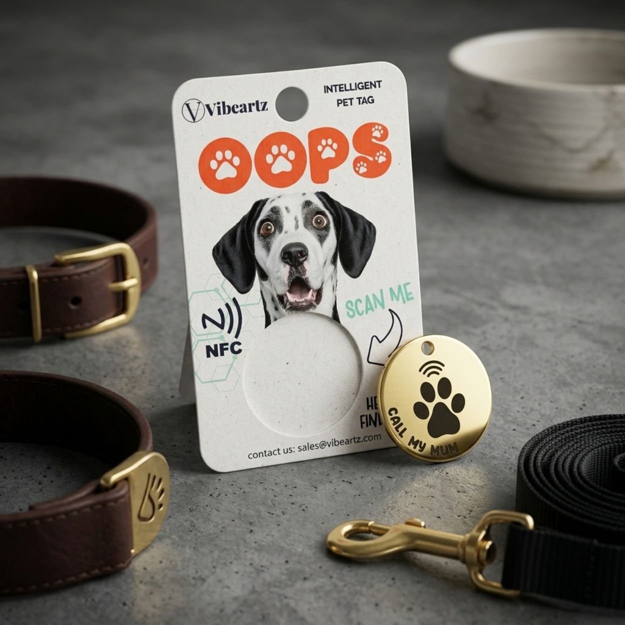 OOPS NFC pet tag packaging beside a leather lead and dog bowl