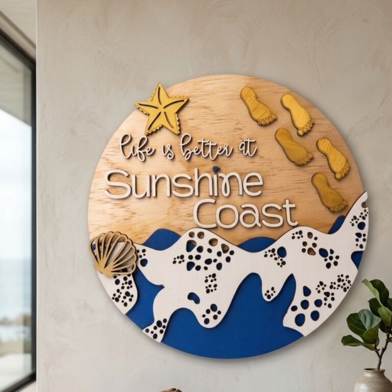 Circular layered wood art featuring starfish, seashell and blue wave design