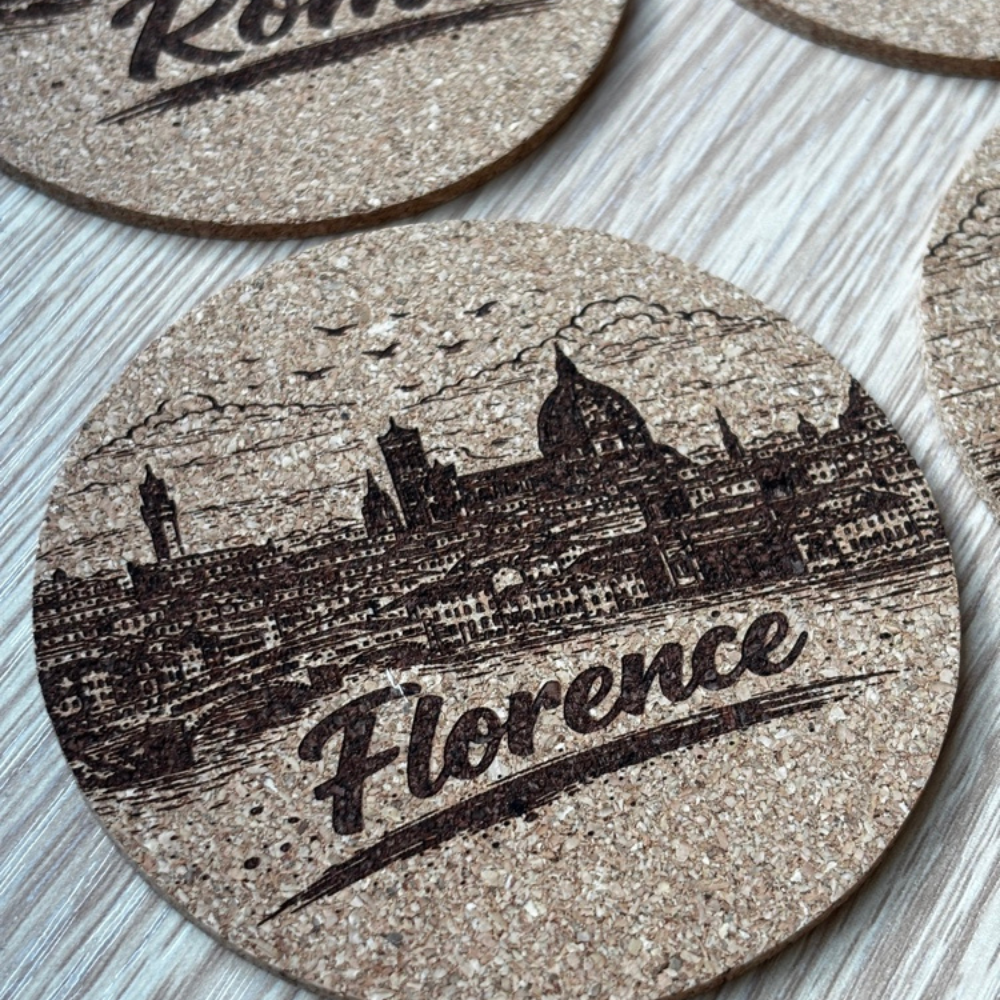 Round cork drink coasters with detailed laser engraved Italian city landscapes and destination names