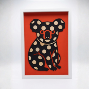 Hand-painted spotted koala wall art made from pine plywood in an A3 white frame